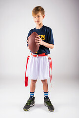 Little boy ready to play flag football in his uniform