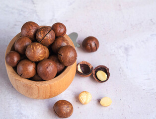 natural organic macadamia nuts in a wooden bowl