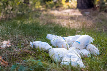 Used dirty diapers on the grass. Ecology, environmental pollution concept.