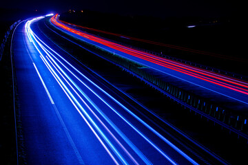 Fototapeta na wymiar Night road lights. Lights of moving cars at night. long exposure red, blue, green