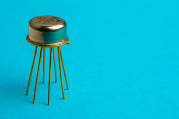 metal golden transistor over blue background