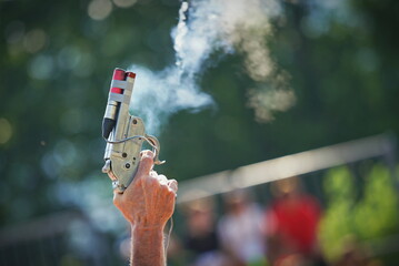 Starting pistol being fired.Hand firing a gun for starting race