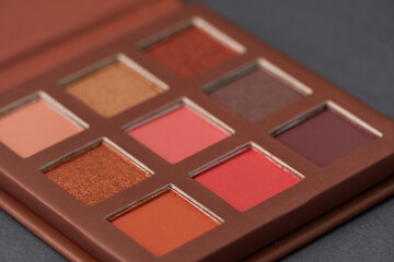 Artistic photography of cosmetics. Eye shadows on a grey background