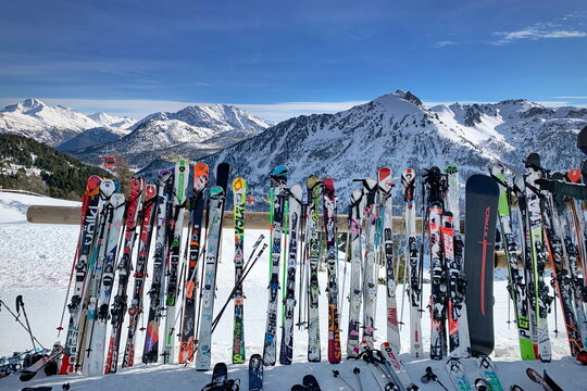 Montgen&egrave;vre, France - December 2018:  A line of skis and snowboards stored on racks outside a cafe. Ski Resort in the Hautes Alpes