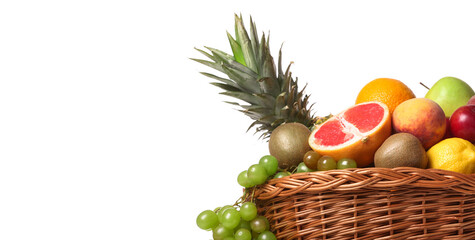 Basket with fresh fruits on white background with space for text