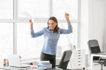 Young businesswoman dancing in office