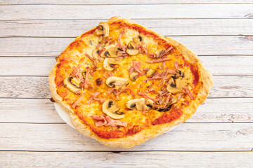 Italian mushroom pizza with cooked ham and oregano with olive oil and fried tomato