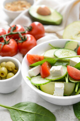 Plate with healthy salad on light background