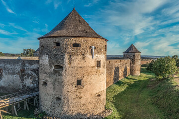 Fototapeta na wymiar Aerial view of Bzovik, Bozok fortified monastery church in southern Slovakia with two round cannon towers and bridge over the dry moat