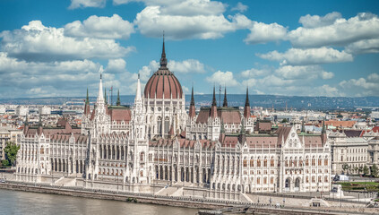 Fototapeta na wymiar Classic view of the Parliament building in Budapest seat of the Hungarian government built in Neo Gothic style along the Danube river with cloudy blue sky