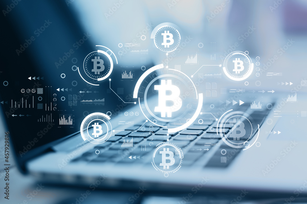 Poster Close up of computer at blurry desktop with creative glowing blue bitcoin interface on dark background. Finance, technology, cryptocurrency and exchange concept. Double exposure.