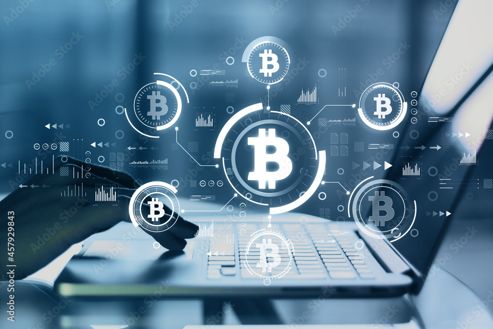 Poster backlit female hands using laptop at blurry desktop with creative glowing blue bitcoin interface on 