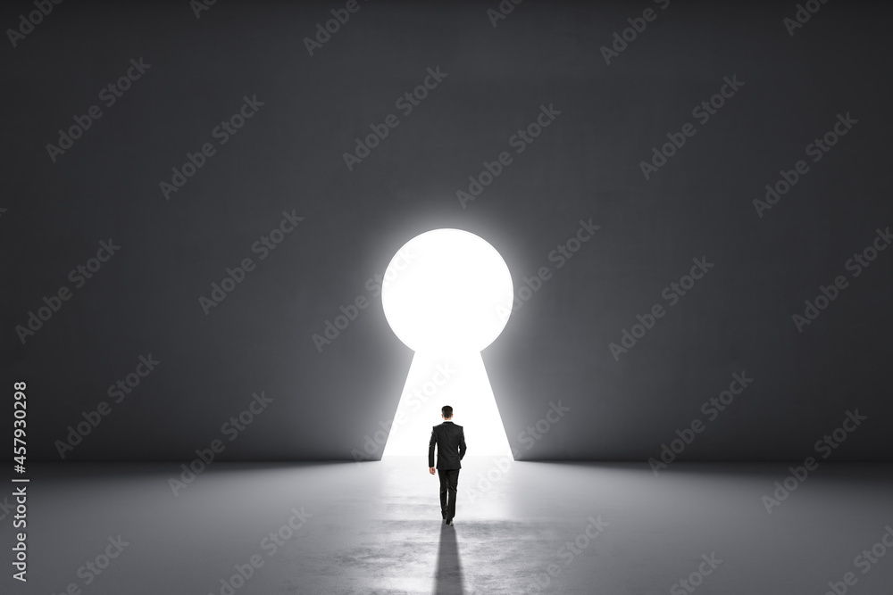 Poster Back view of businessman walking in concrete interior with abstract keyhole window. Key to success and abundance concept. Mock up place.