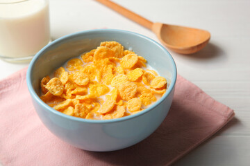  Crispy cornflakes with milk for breakfast on the table close-up.