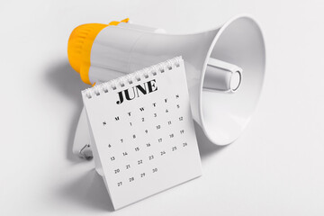 Modern megaphone and flip calendar on light background