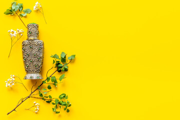 Silver bottle of arabian oud perfume or agar wood oil