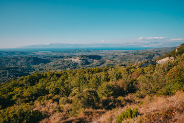 Beautiful summer landscape of south Greece island in Europe. Mediterranean Ionian sea and mountains on horizon.