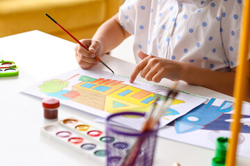Naklejka premium Cute little girl painting at table, closeup