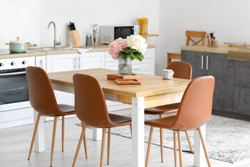 Interior of stylish kitchen with dining table