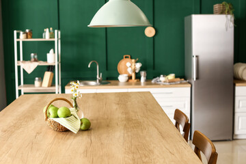 Interior of stylish kitchen with green apples on dining table