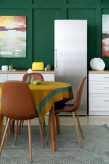 Interior of stylish kitchen with dining table and chairs