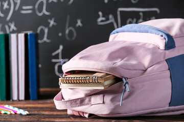 Stylish school backpack on table in classroom, closeup