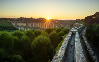 Plakat View over the Pegões aqueduct with a beautiful sunset in the background, near the city of Tomar in Portugal.