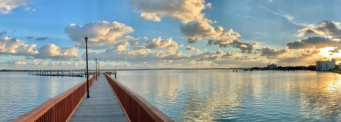 Morning sunrise on the boardwalk along the St Lucie River walk in Stuart, Florida.  - obrazy, fototapety, plakaty