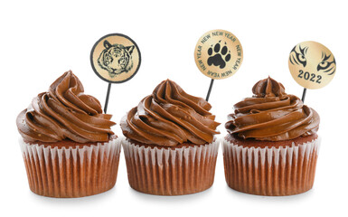 Tasty cupcakes for New Year 2022 celebration on white background