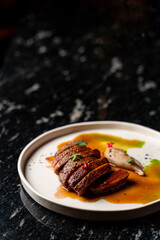 Veal steak cut and rooted with a liver pate, top view, fine dining restaurant