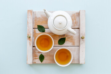 Asian food and drink background white teapot and black tea in two cups