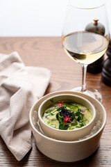 Top view of gourmet cold soup with spinach and black caviar