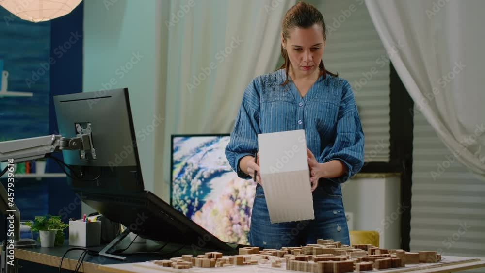 Poster architect holding maquette in hand using touch screen computer for construction development. woman e
