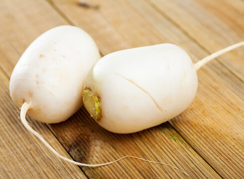 Ripe white radish on a wooden table. High quality photo