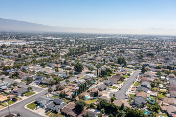 Aerial view of a suburban neighborhood sunny day with haze