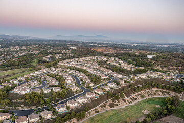 Aerial view of a gorgeous southern California sunset from an upscale neighborhood on a golf course. 