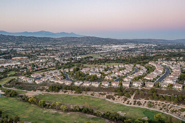 Aerial view of a gorgeous southern California sunset from an upscale neighborhood on a golf course. 