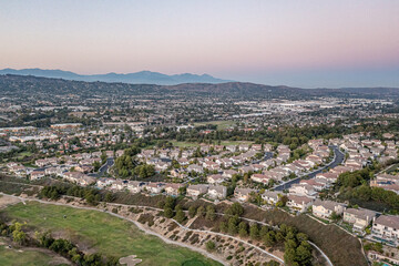 Aerial view of a gorgeous southern California sunset from an upscale neighborhood on a golf course. 