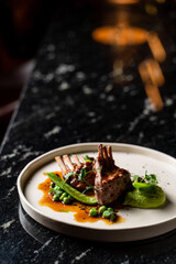 Close up of juicy roasted ribs on black marble background