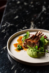 Close up of juicy roasted ribs on black marble background