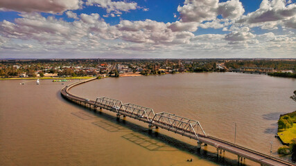 Fototapeta premium Puffy Clouds Over the Bridge into Yarrawonga