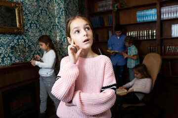 Emotional girl in quest room with friends, trying to find solution of conundrum © JackF