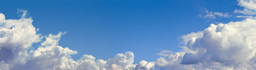 Panorama blue sky with cumulus clouds. High resolution.