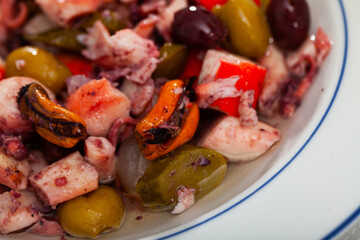 Delicious cold salad from variety of seafood with chopped vegetables (Salpicon de mariscos) typical...
