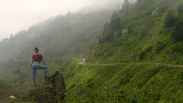 Drone shot of a traveller watching over the road pass on route to Gomi Mountain in the Guria region of Georgia, also known as Gosmismta