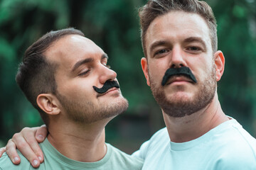 Fototapeta premium portrait of gay couple wearing mustaches