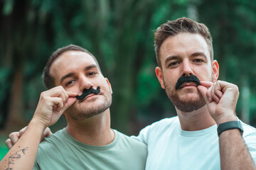 portrait of gay couple wearing mustaches