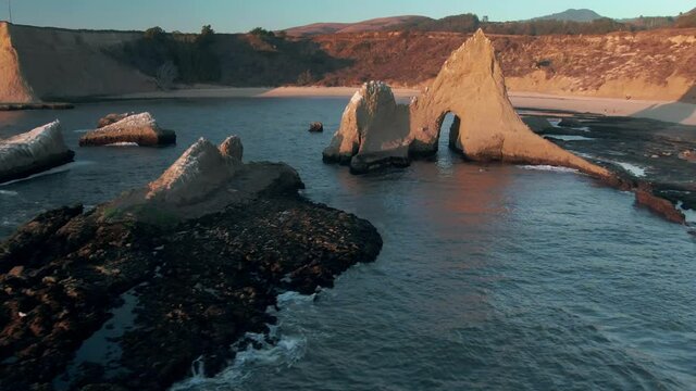 Aerial: Shark Fin rock at sunset on Martin's Beach, California, USA
