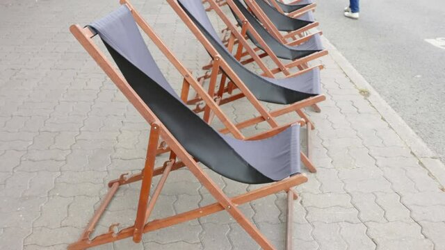 Closer look of the black chair on the streetside on a windy day in Estonia