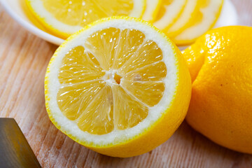 Lemon and knife on cutting board. High quality photo